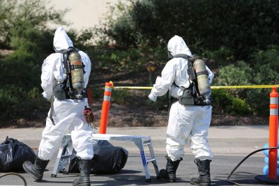 workers wearing oxygen tanks and hazmat suits for chemical removal